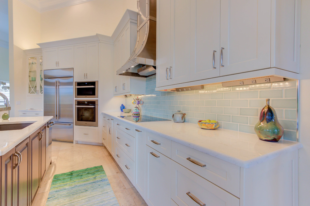 Enclosed kitchen - large transitional single-wall enclosed kitchen idea with an undermount sink, flat-panel cabinets, white cabinets, quartz countertops, blue backsplash, stone tile backsplash, stainless steel appliances and an island