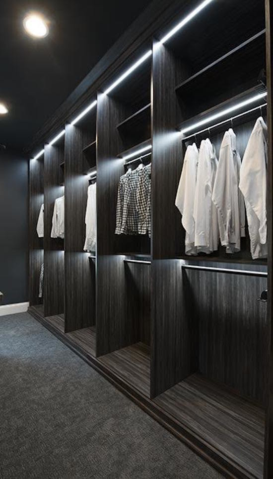 Inspiration for a large classic dressing room for men in DC Metro with flat-panel cabinets, dark wood cabinets, carpet and grey floors.