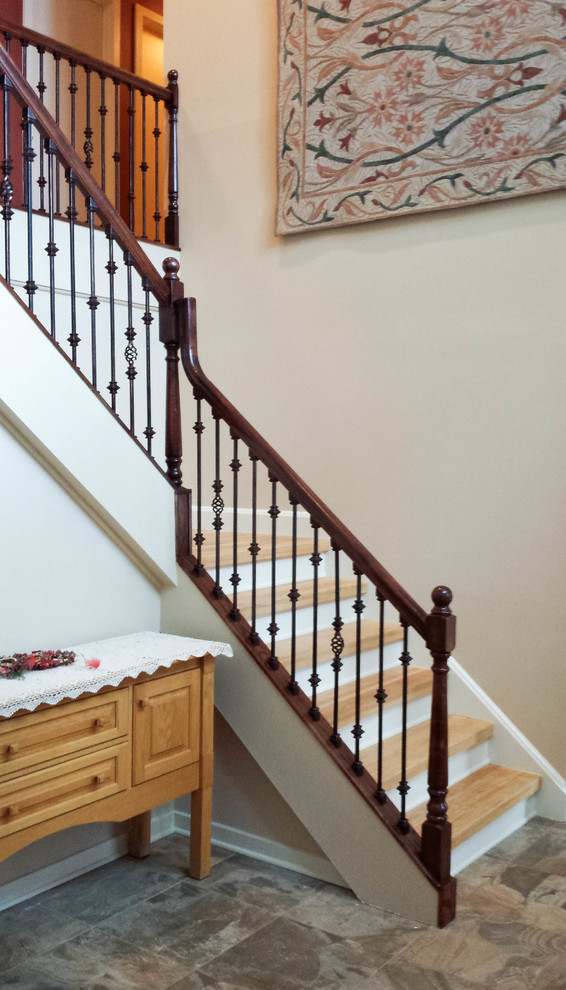 Mid-sized traditional wood l-shaped staircase in New York with wood risers and metal railing.