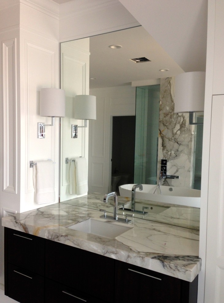 This is an example of a mid-sized transitional master bathroom in Calgary with an undermount sink, flat-panel cabinets, dark wood cabinets, marble benchtops, a freestanding tub, a double shower, white tile, stone tile, marble floors, white walls, beige floor and an open shower.