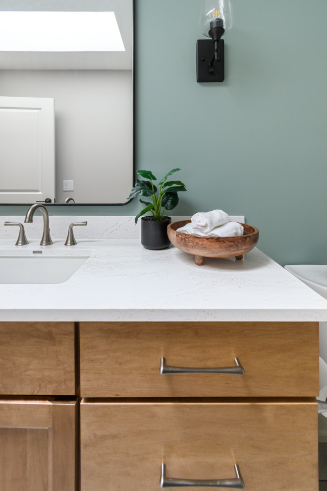 Example of a transitional ceramic tile, white floor and single-sink bathroom design in Minneapolis with shaker cabinets, light wood cabinets, green walls, quartz countertops, white countertops and a built-in vanity