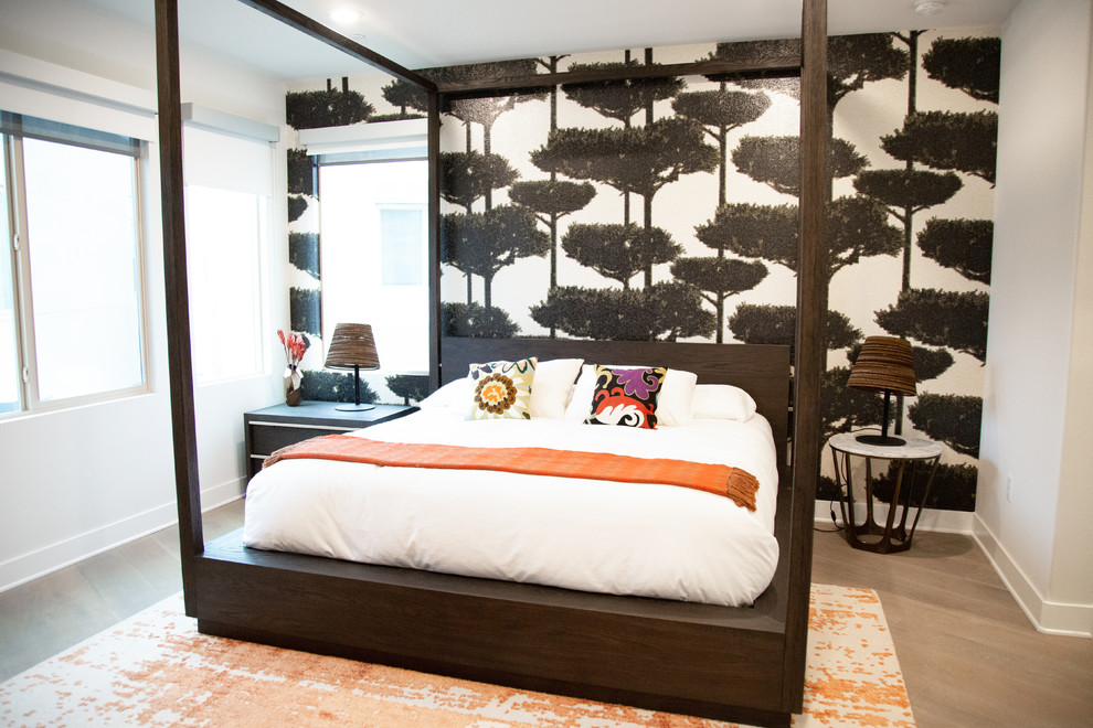 Inspiration for a mid-sized contemporary master bedroom in Orange County with white walls, medium hardwood floors and grey floor.