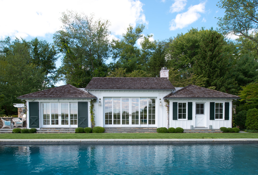 Mid-sized traditional two-storey white exterior in New York with wood siding, a hip roof and a shingle roof.