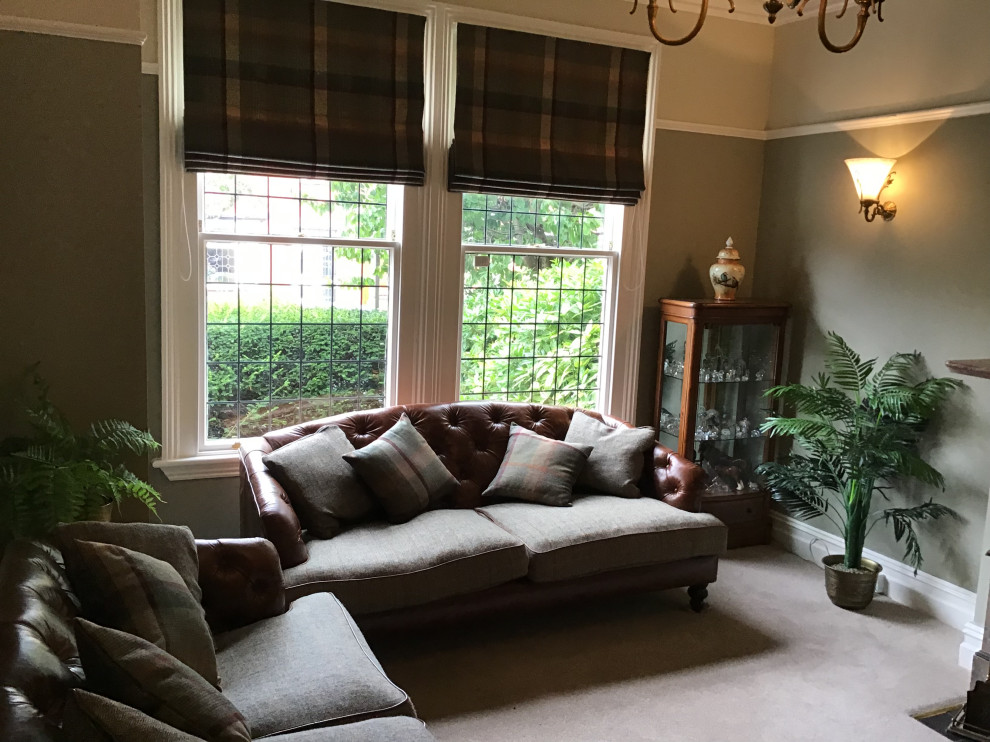 Inspiration for a mid-sized country formal enclosed living room in Cheshire with green walls, carpet, a standard fireplace, a stone fireplace surround, a freestanding tv and beige floor.