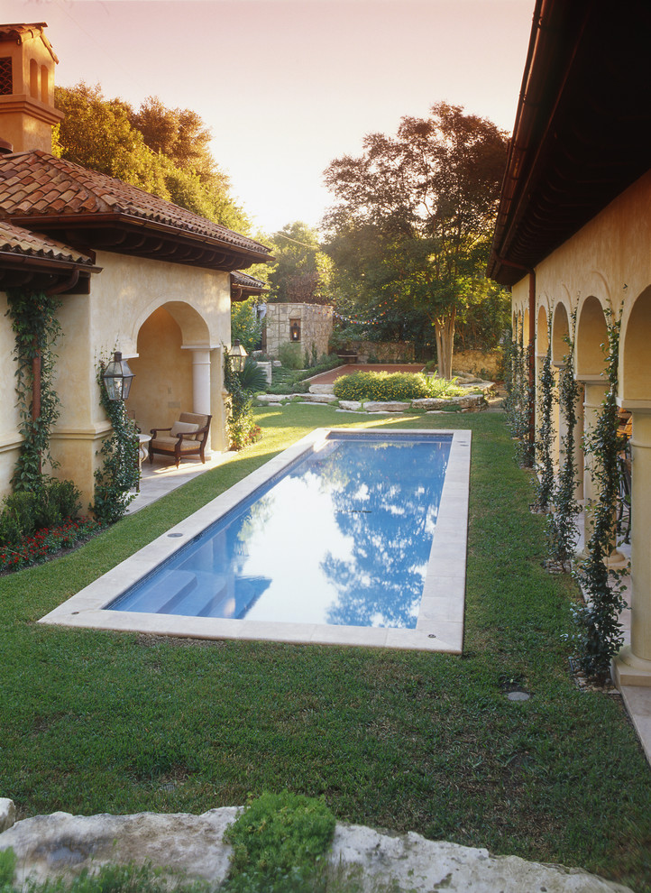 Inspiration for a mid-sized mediterranean backyard rectangular lap pool in Austin with a pool house and tile.