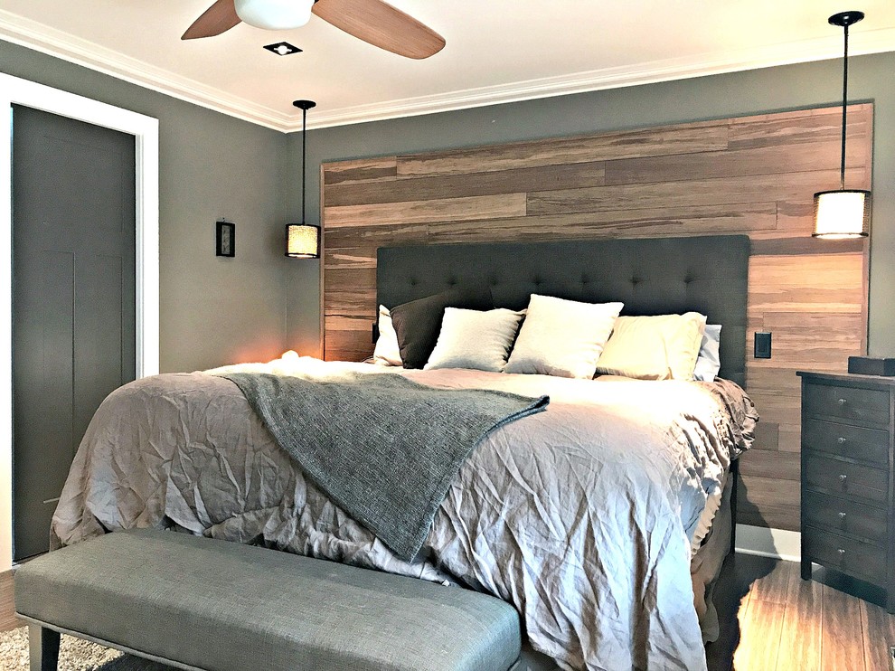 Photo of a mid-sized transitional master bedroom in Denver with brown walls, bamboo floors and brown floor.
