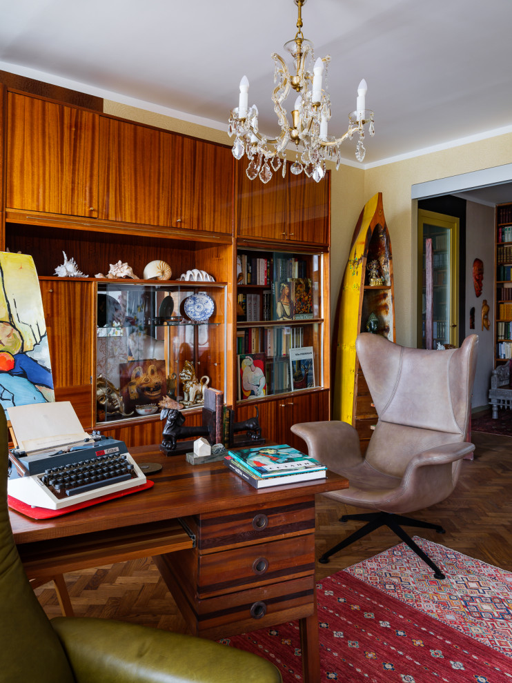 This is an example of a small eclectic study room in Moscow with multi-coloured walls, dark hardwood floors, no fireplace, a freestanding desk, brown floor and wallpaper.