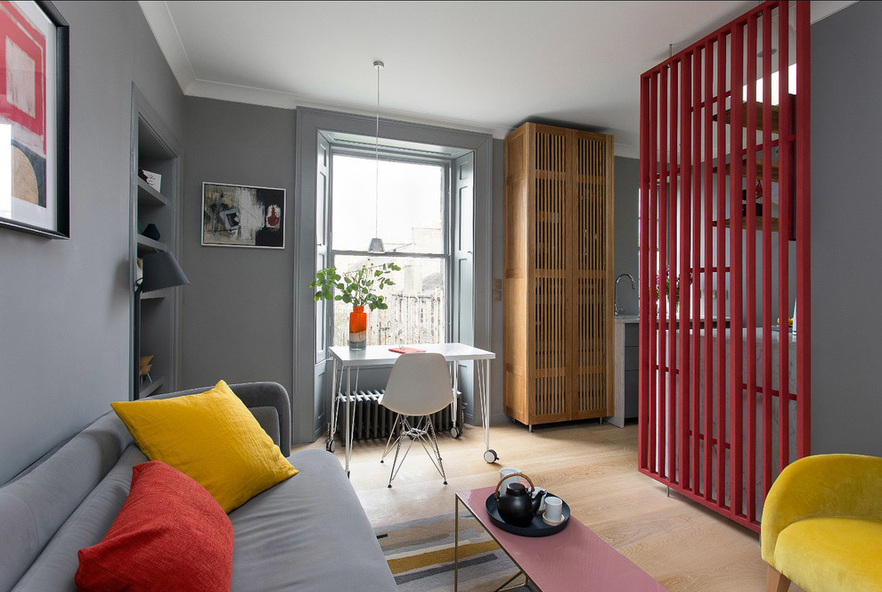 Contemporary open plan living room in Edinburgh with grey walls, light hardwood flooring, no fireplace, a wall mounted tv and beige floors.