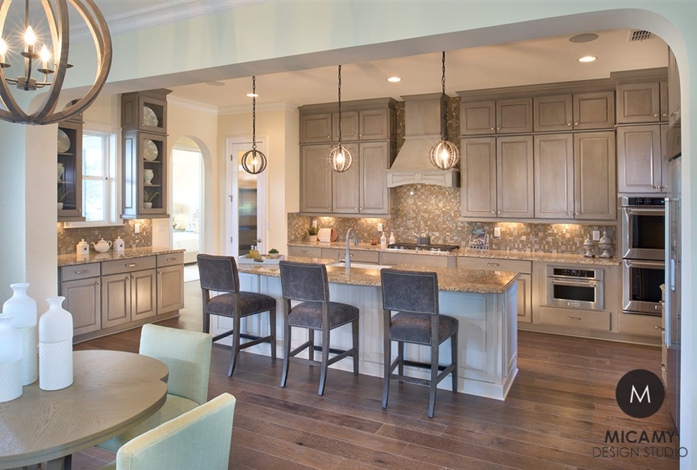 Open concept kitchen - large transitional u-shaped medium tone wood floor open concept kitchen idea in Jacksonville with a double-bowl sink, flat-panel cabinets, gray cabinets, granite countertops, brown backsplash, glass tile backsplash, stainless steel appliances and an island