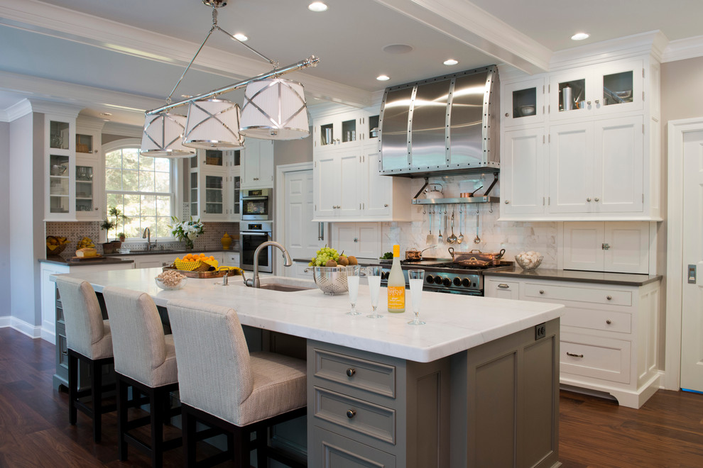 Inspiration for a traditional l-shaped kitchen in Philadelphia with an undermount sink, shaker cabinets, white cabinets, white splashback and stainless steel appliances.