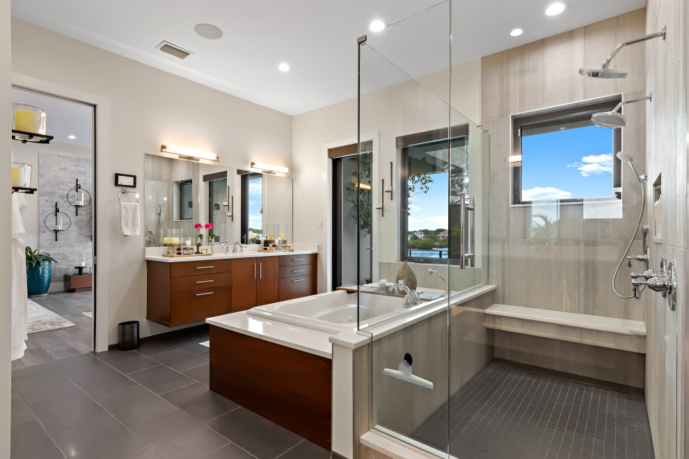 Mid-sized contemporary master bathroom in Tampa with flat-panel cabinets, dark wood cabinets, a hot tub, a corner shower, gray tile, stone tile, beige walls, porcelain floors, an undermount sink, engineered quartz benchtops, grey floor, a hinged shower door, white benchtops, a single vanity and a built-in vanity.
