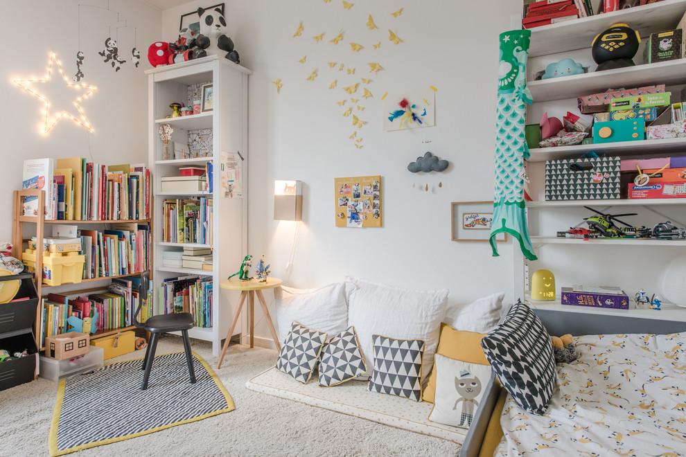 This is an example of an eclectic kids' playroom for kids 4-10 years old in Montpellier with white walls, carpet and beige floor.