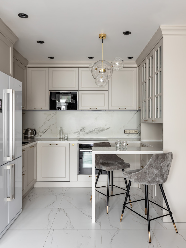 Inspiration for a mid-sized transitional u-shaped kitchen in Saint Petersburg with recessed-panel cabinets, beige cabinets, grey splashback, porcelain floors, a peninsula, grey floor and white benchtop.