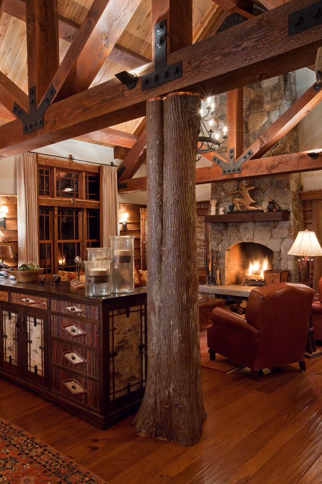 Mountain style formal and open concept medium tone wood floor living room photo in Boston with a standard fireplace, a stone fireplace and no tv