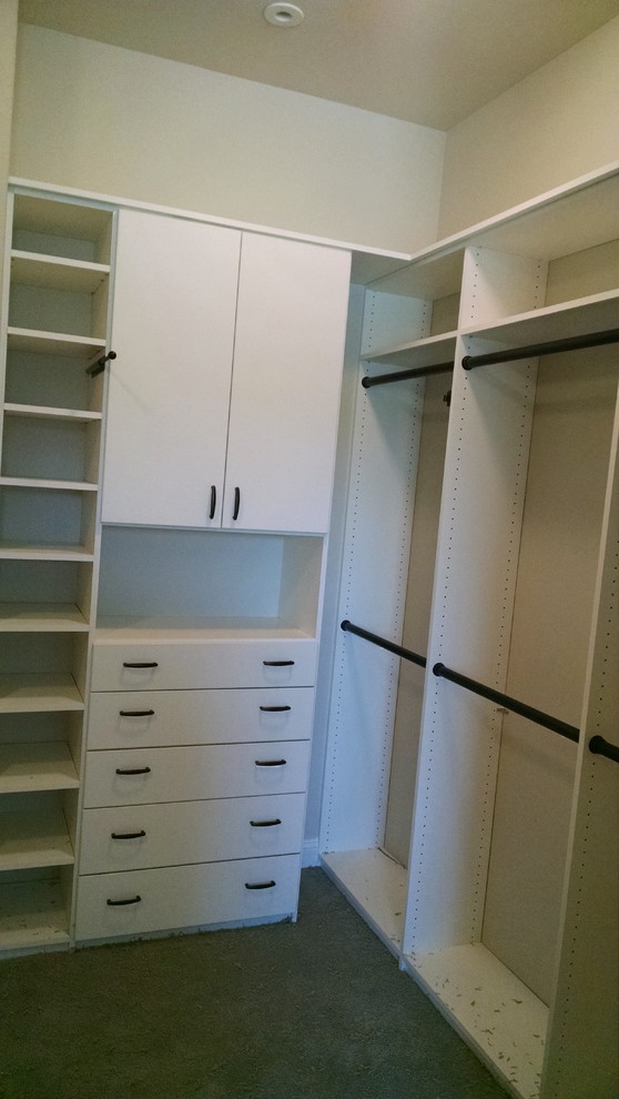 Mid-sized modern gender-neutral walk-in wardrobe in Denver with open cabinets, white cabinets and carpet.