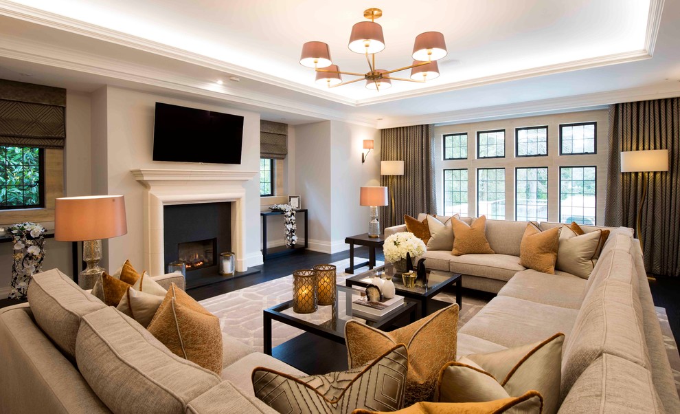 This is an example of a mid-sized transitional living room in West Midlands with beige walls, black floor, a stone fireplace surround and coffered.