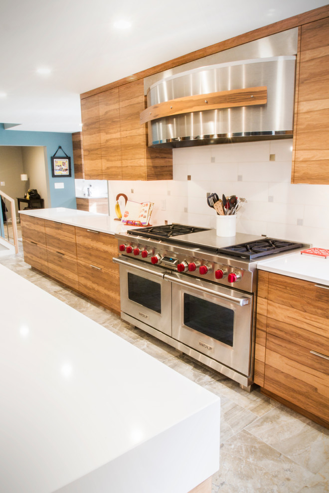 Expansive modern l-shaped kitchen pantry in Other with an undermount sink, flat-panel cabinets, medium wood cabinets, quartz benchtops, multi-coloured splashback, subway tile splashback, stainless steel appliances, ceramic floors and with island.