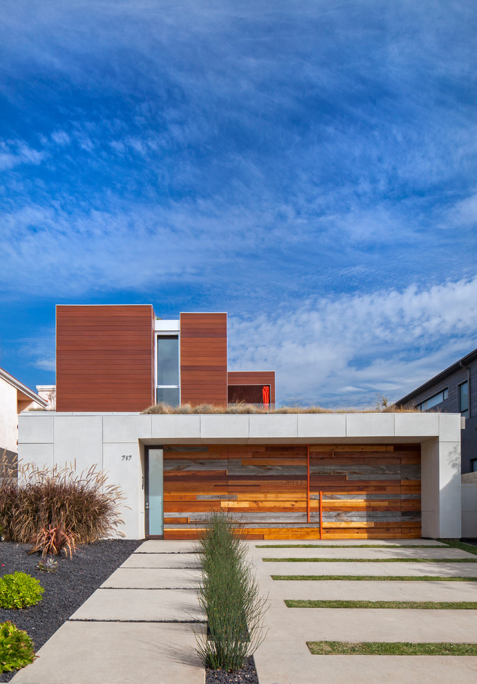 Contemporary two-storey brown house exterior in Los Angeles with mixed siding, a flat roof and a green roof.
