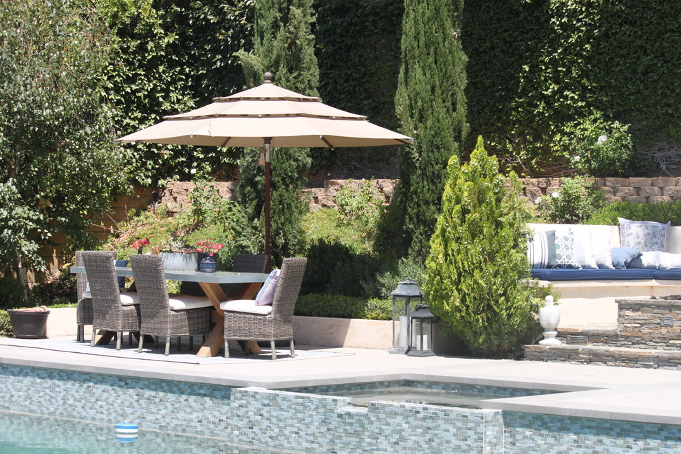 Inspiration for a large transitional backyard concrete and rectangular pool remodel in Los Angeles