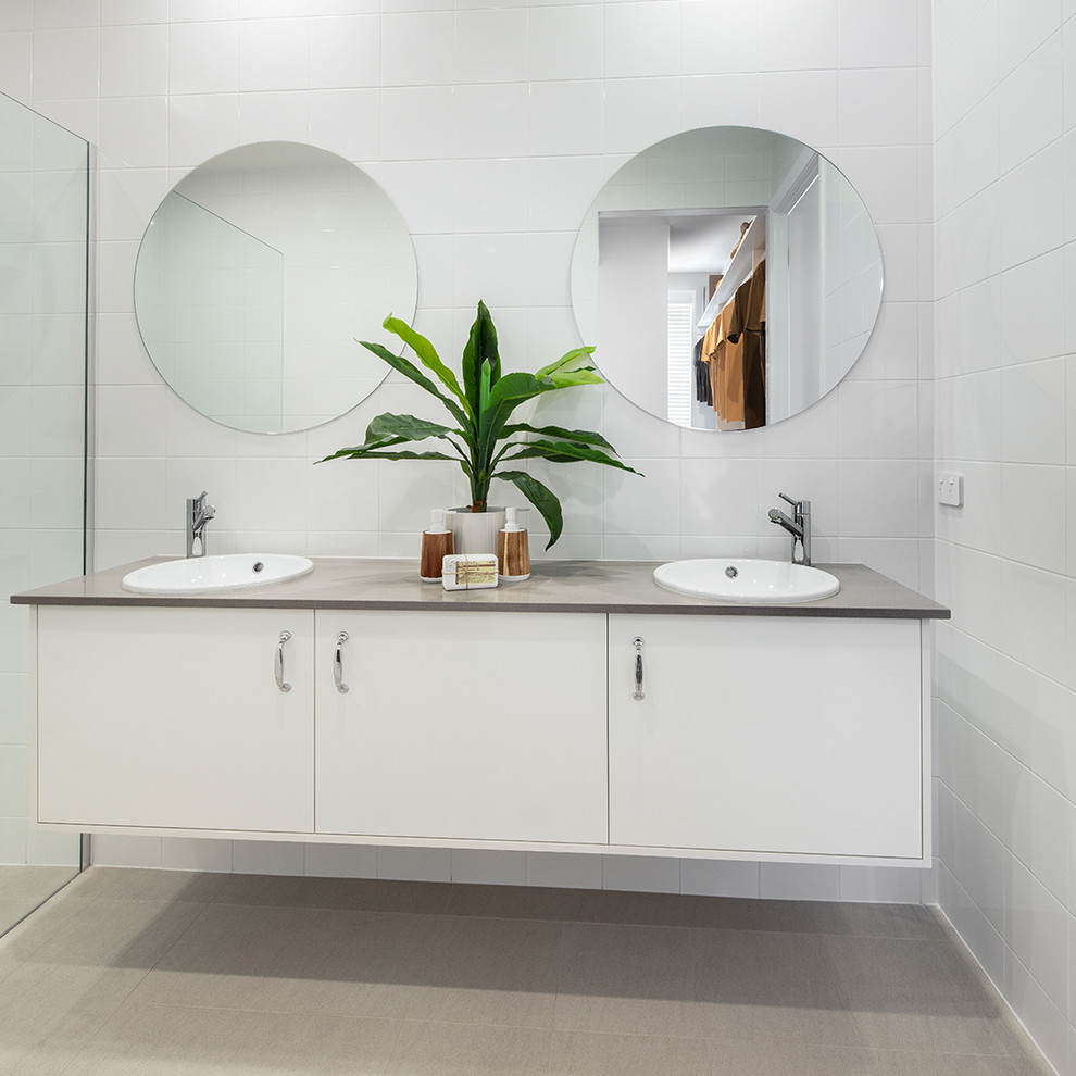 Inspiration for a large midcentury master bathroom in Canberra - Queanbeyan with white cabinets, a corner shower, white tile, ceramic tile, white walls, cement tiles, a drop-in sink, granite benchtops, beige floor, an open shower, grey benchtops and flat-panel cabinets.