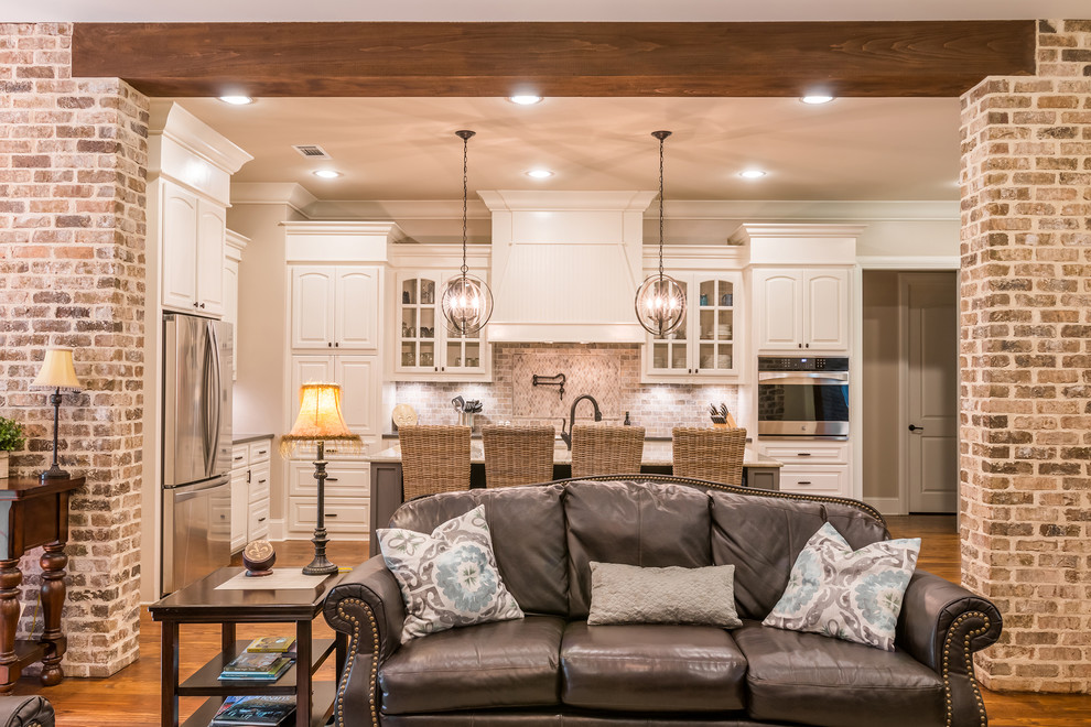 Mid-sized transitional open concept family room in Other with beige walls, medium hardwood floors, no fireplace, a wall-mounted tv and brown floor.