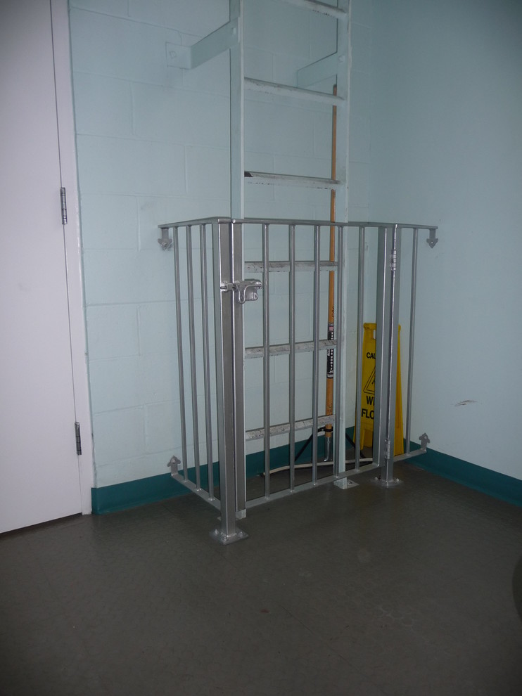 Minimalist straight metal railing staircase photo in Boston