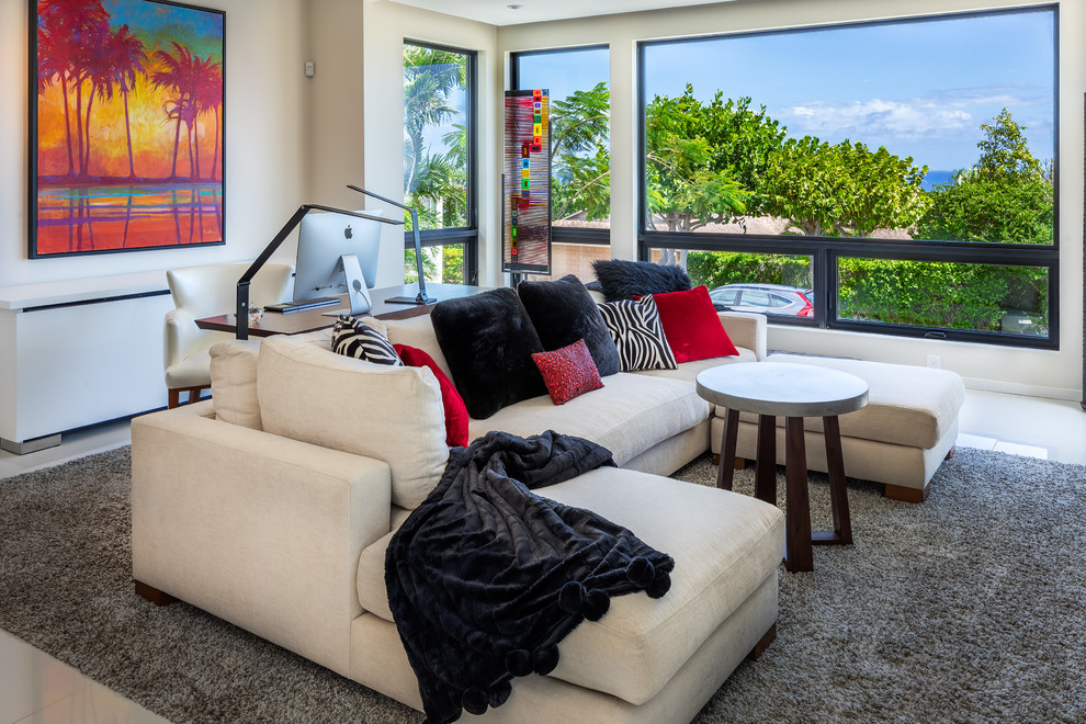 This is an example of a large modern open concept living room in Hawaii with white walls, no fireplace, a wall-mounted tv and white floor.