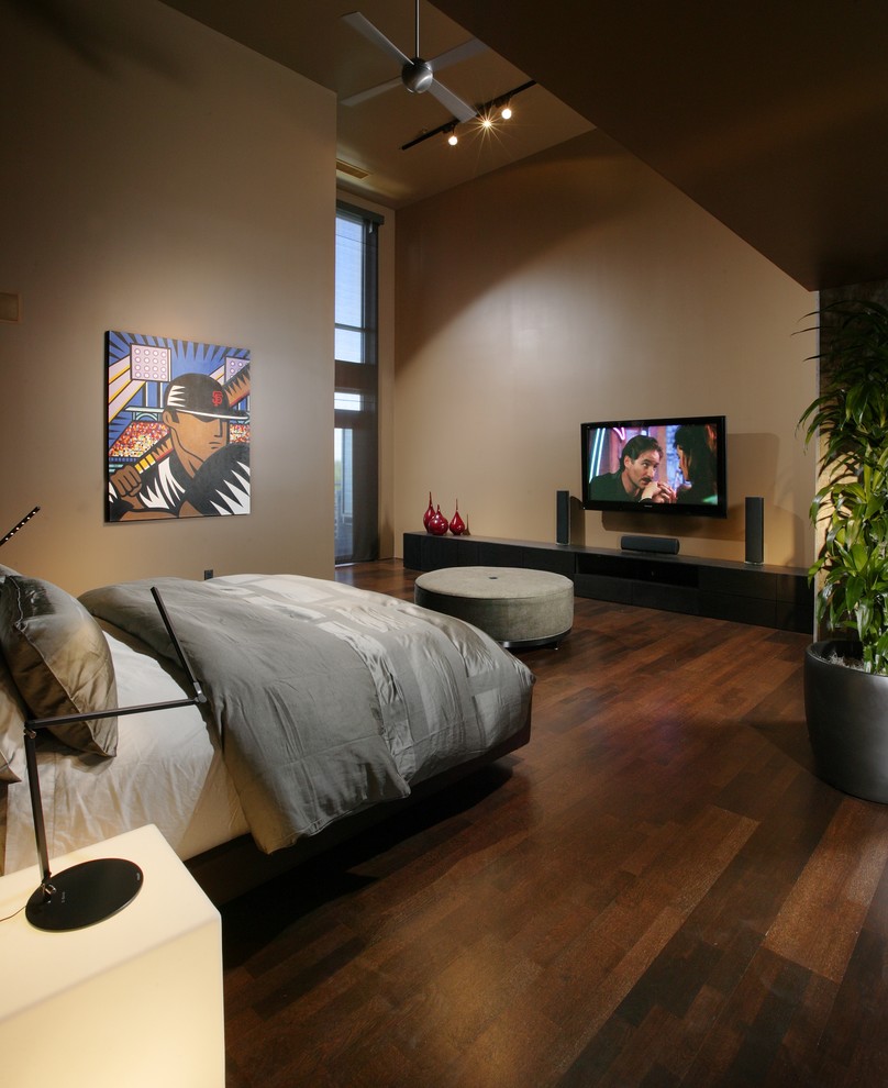 This is an example of a contemporary bedroom in Sacramento with brown walls, dark hardwood floors and no fireplace.