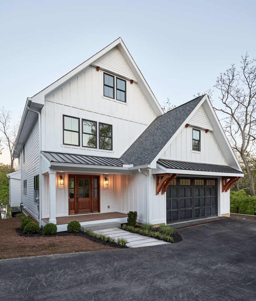 This is an example of a mid-sized country two-storey white house exterior in Cincinnati with concrete fiberboard siding, a mixed roof, a grey roof and board and batten siding.