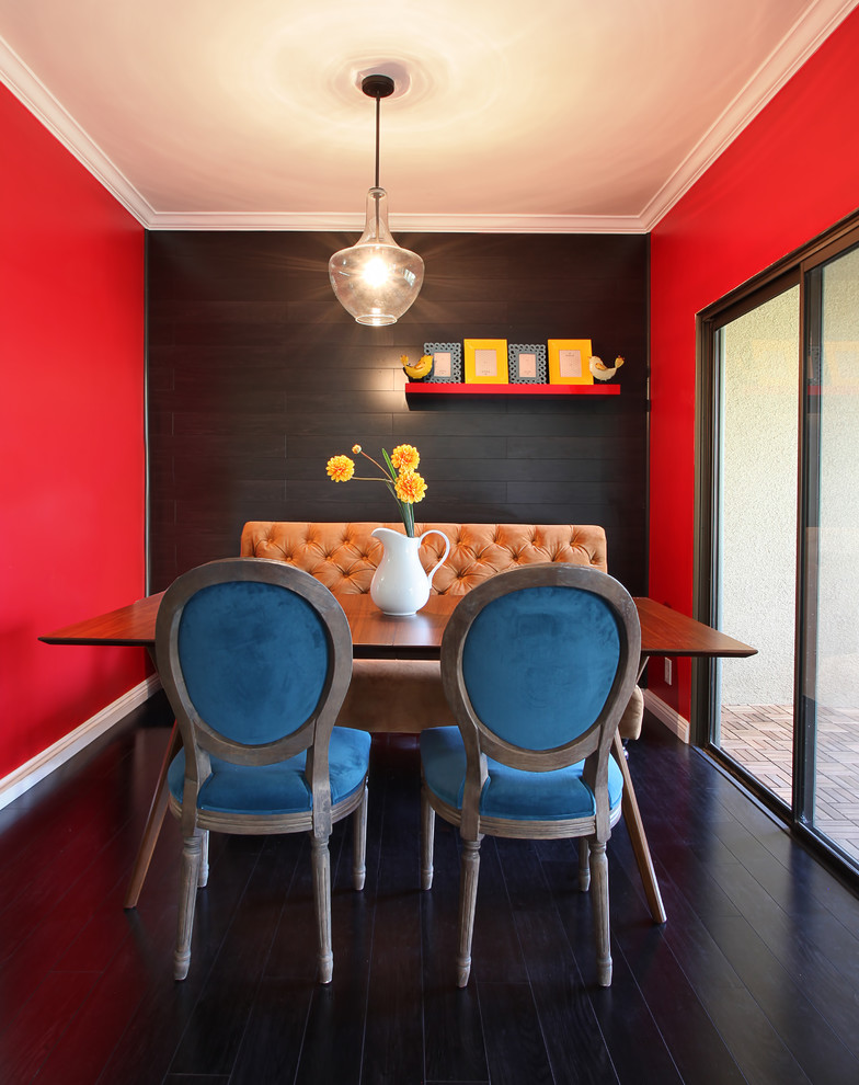 This is an example of a transitional dining room in Los Angeles with red walls.