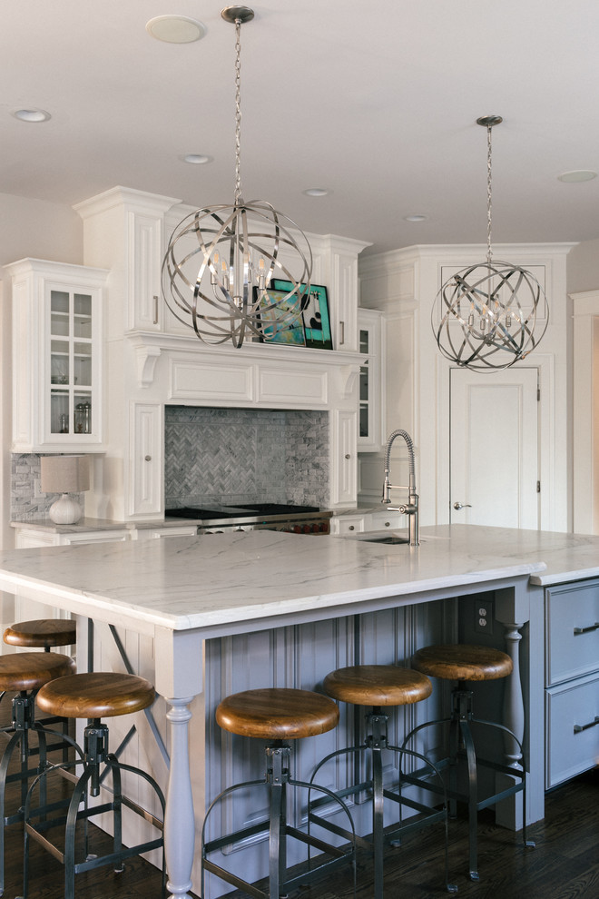 Inspiration for a large transitional u-shaped medium tone wood floor and brown floor eat-in kitchen remodel in Atlanta with an undermount sink, raised-panel cabinets, white cabinets, marble countertops, white backsplash, marble backsplash, stainless steel appliances and an island