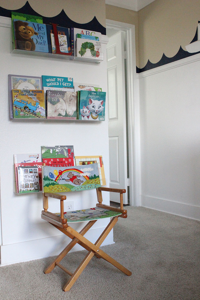 Small beach style nursery in Orange County with multi-coloured walls, carpet and beige floor for boys.