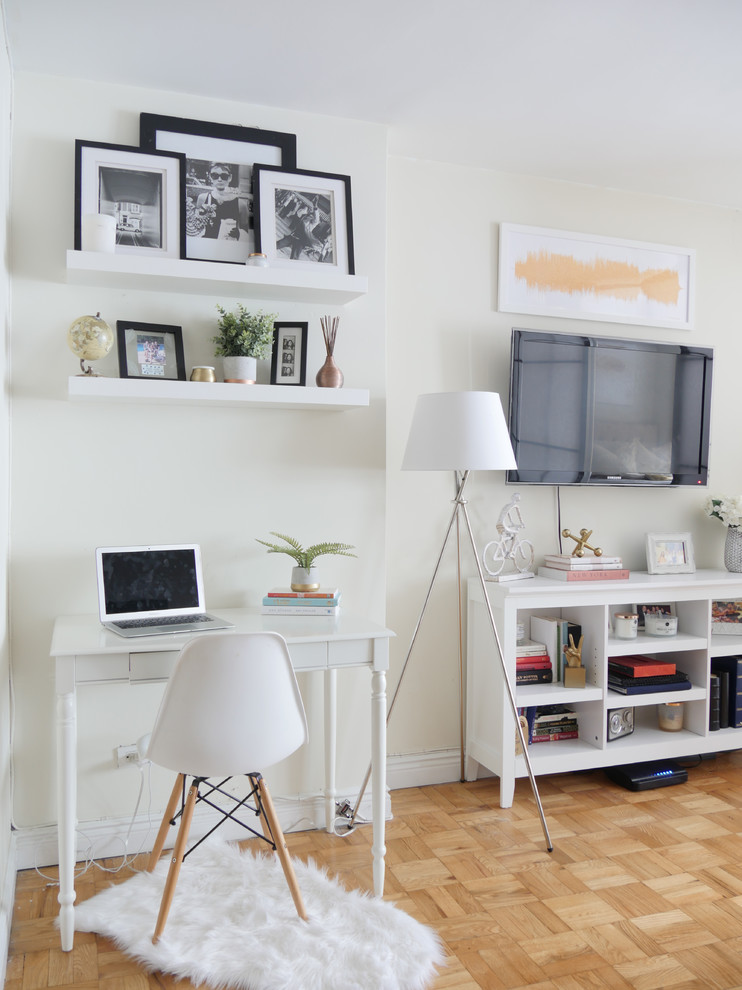 This is an example of a small traditional enclosed living room in New York with white walls.