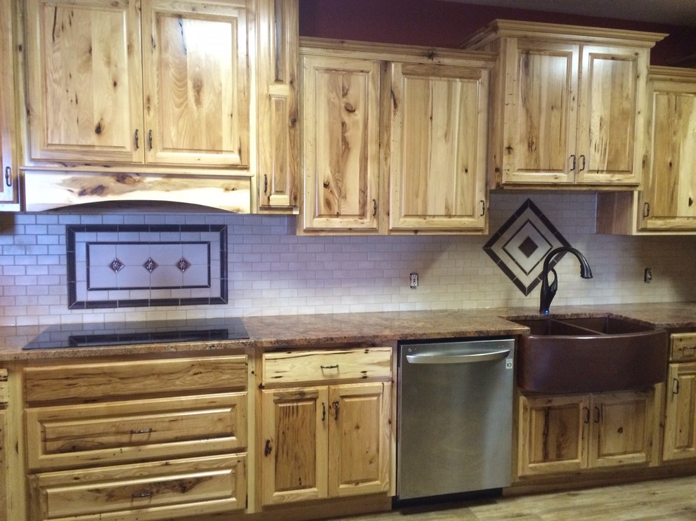 Inspiration for a rustic porcelain tile eat-in kitchen remodel in St Louis with a farmhouse sink and raised-panel cabinets