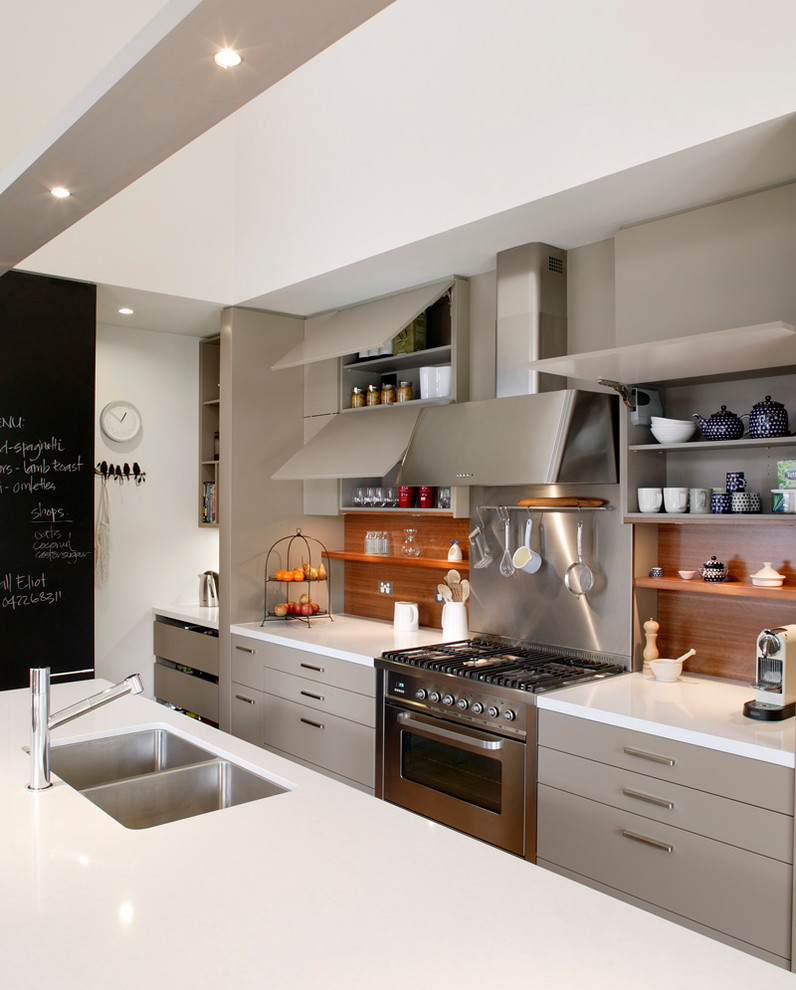 Photo of a mid-sized contemporary l-shaped eat-in kitchen in Sydney with a double-bowl sink, flat-panel cabinets, beige cabinets, brown splashback, stainless steel appliances, quartz benchtops, timber splashback, medium hardwood floors and with island.