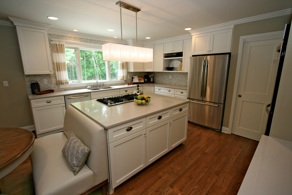 Large transitional medium tone wood floor kitchen photo in Cincinnati with an undermount sink, flat-panel cabinets, white cabinets, quartz countertops, gray backsplash, porcelain backsplash, stainless steel appliances and an island