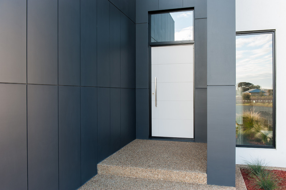 Mid-sized modern front door in Melbourne with grey walls, concrete floors, a pivot front door and a white front door.