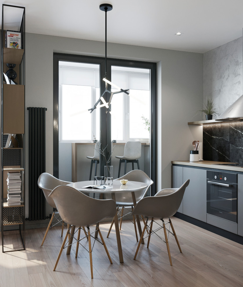 Inspiration for a mid-sized contemporary l-shaped open plan kitchen in Other with a drop-in sink, flat-panel cabinets, grey cabinets, wood benchtops, grey splashback, porcelain splashback, stainless steel appliances, laminate floors, no island, beige floor and beige benchtop.