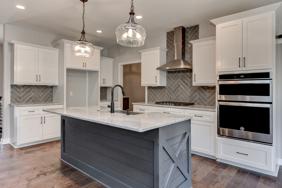 Inspiration for a transitional l-shaped eat-in kitchen remodel in Omaha with an island