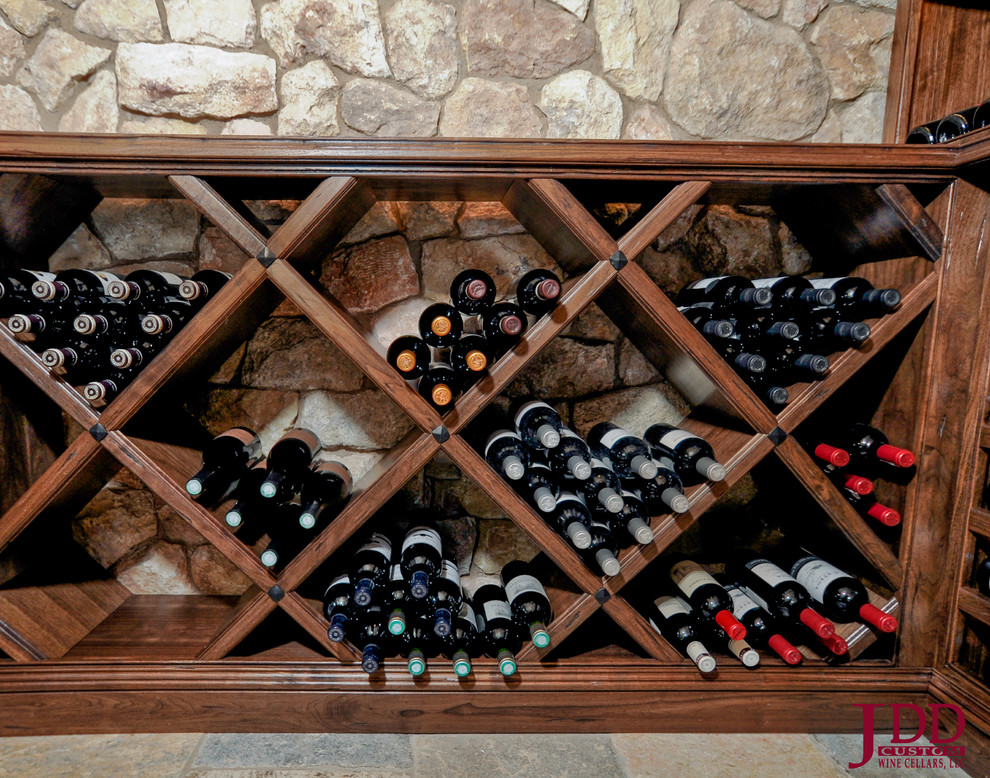 Inspiration for a mid-sized midcentury wine cellar in San Diego with travertine floors and display racks.