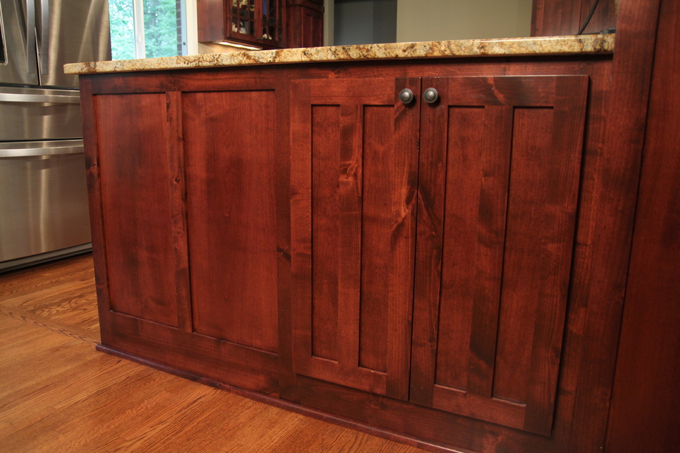 Example of a mountain style kitchen design in Minneapolis with flat-panel cabinets and medium tone wood cabinets