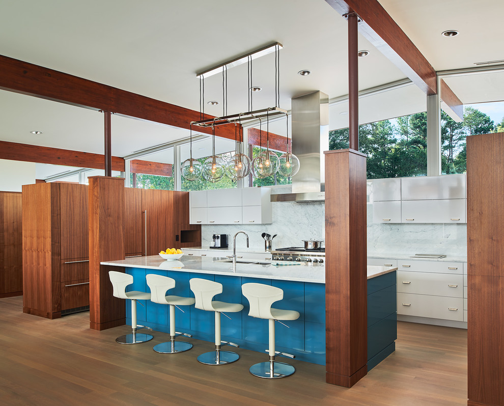 Mid-sized mid-century modern u-shaped light wood floor and brown floor open concept kitchen photo in DC Metro with flat-panel cabinets, white cabinets, marble countertops, marble backsplash, an island, a double-bowl sink, white backsplash and stainless steel appliances