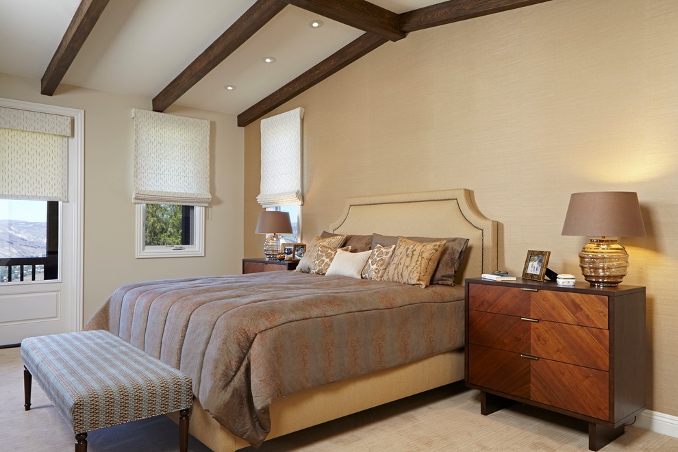 Inspiration for an expansive mediterranean master bedroom in Los Angeles with beige walls and carpet.