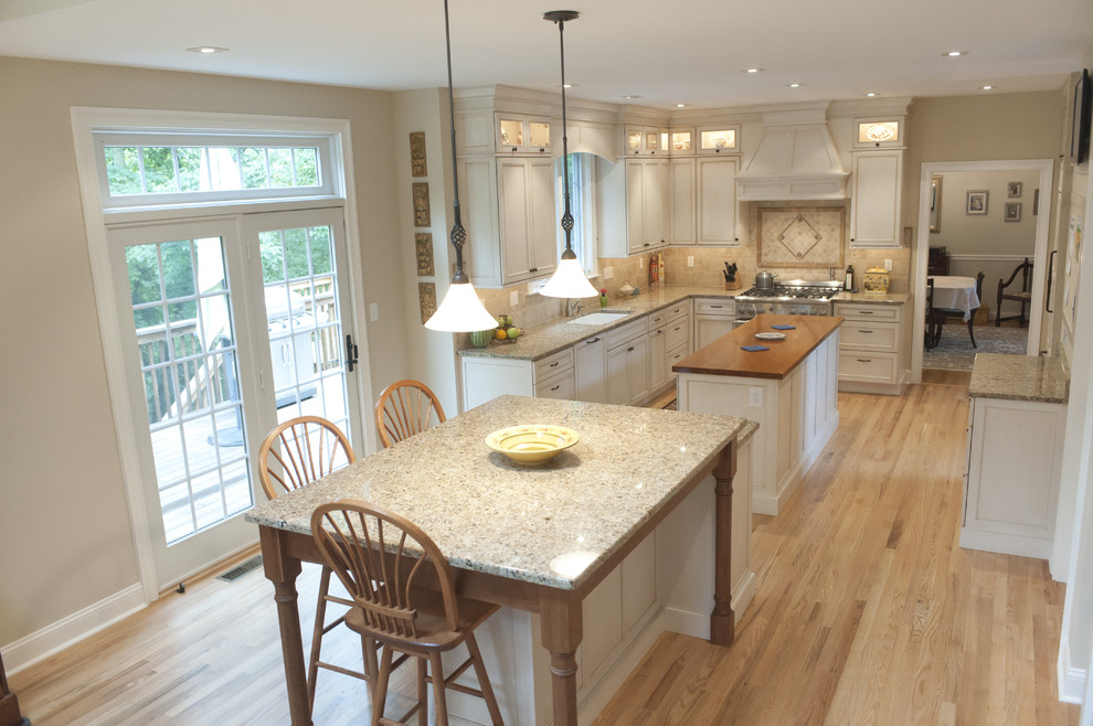 Design ideas for a traditional kitchen in Philadelphia with light hardwood floors and multiple islands.