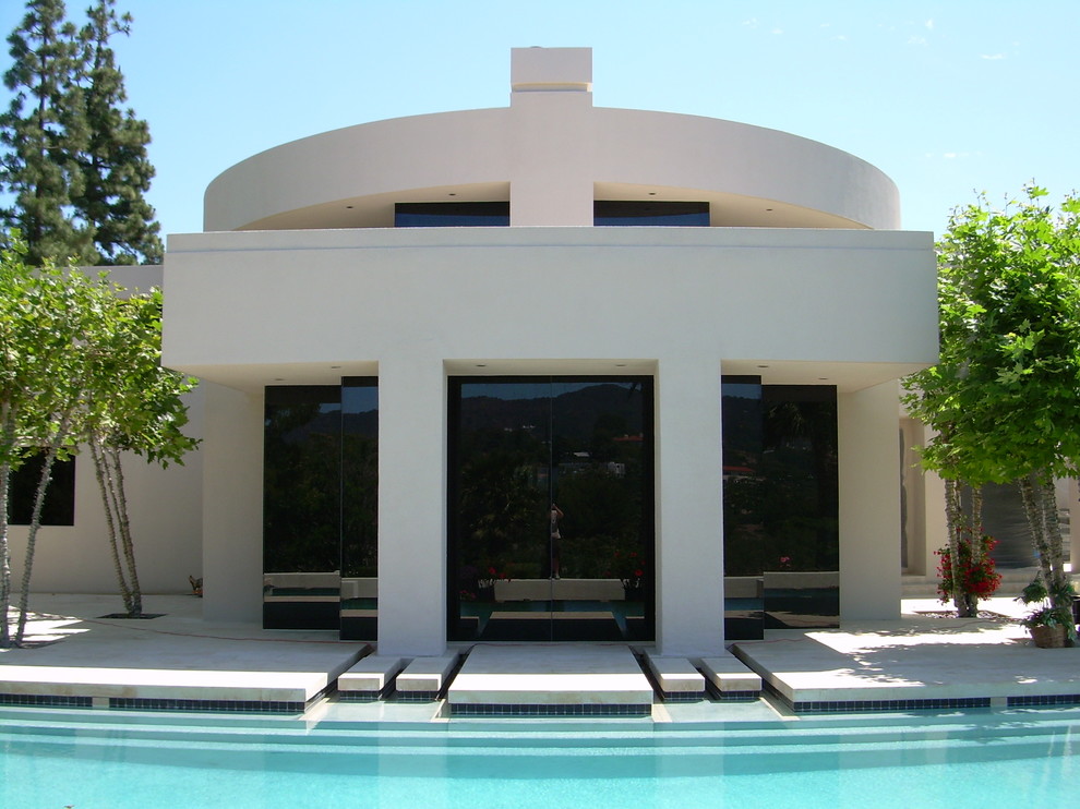 Photo of a large contemporary two-storey stucco white exterior in Los Angeles with a flat roof.