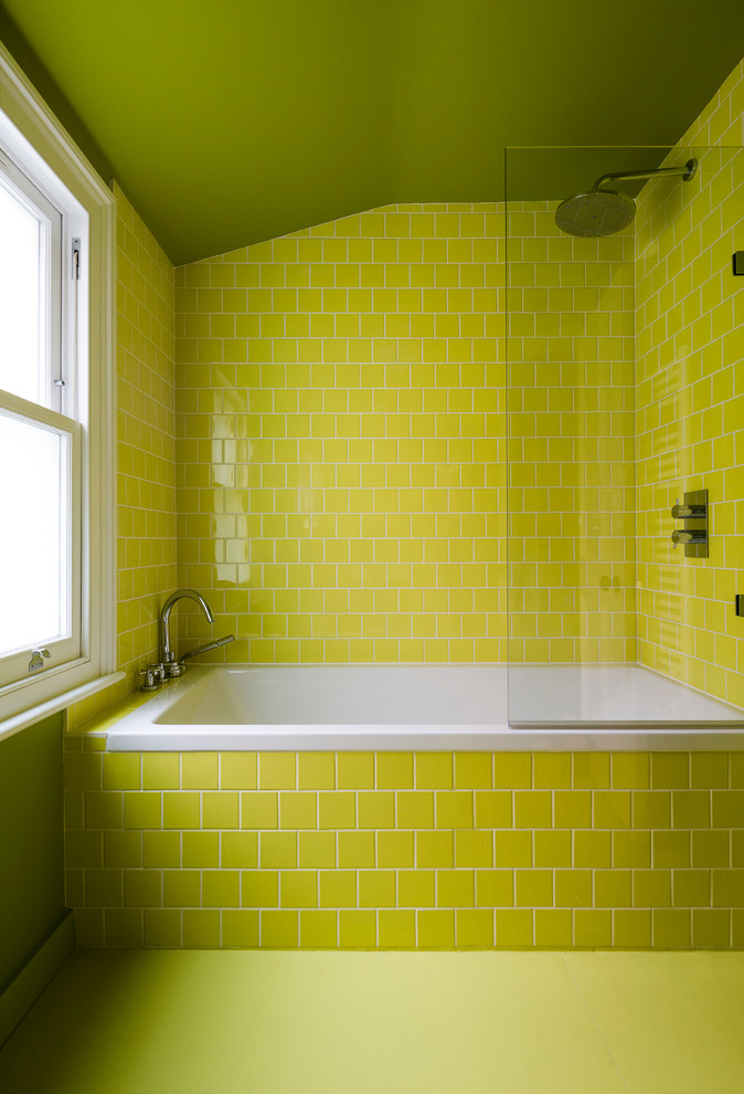 Inspiration for a small contemporary kids bathroom in London with flat-panel cabinets, green cabinets, a drop-in tub, a curbless shower, a wall-mount toilet, green tile, ceramic tile, green walls and a wall-mount sink.