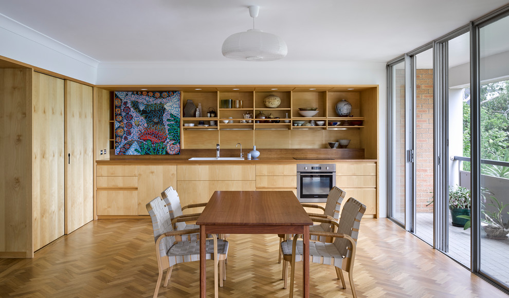 Design ideas for a scandinavian separate dining room in Brisbane with white walls, light hardwood floors and beige floor.