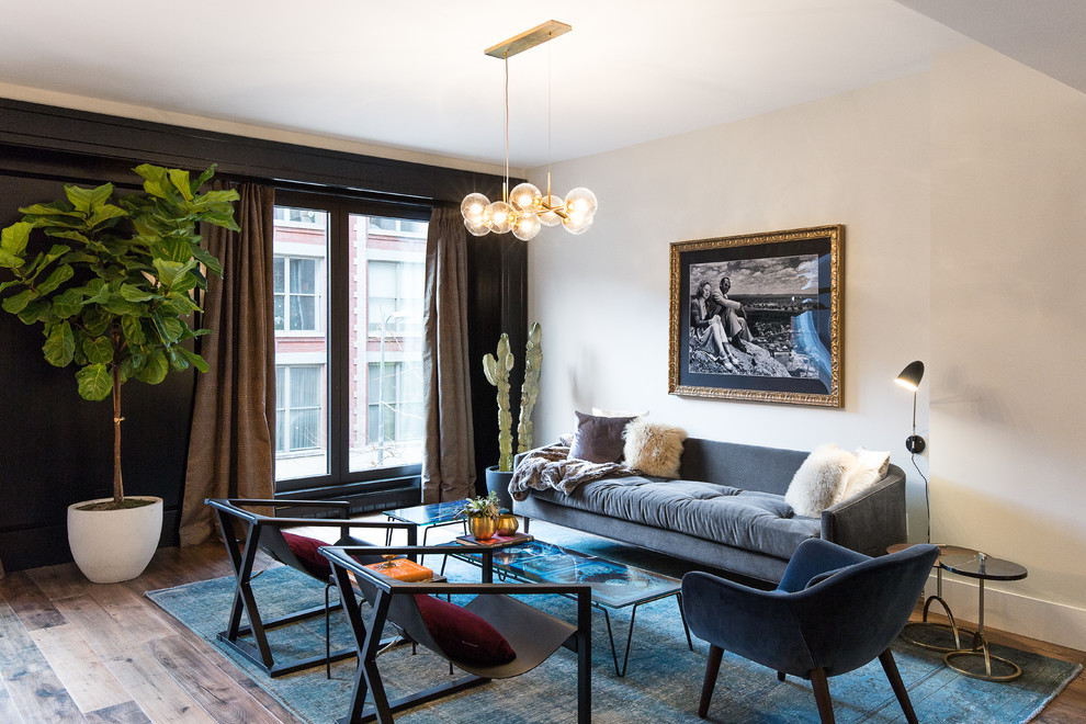 Mid-sized trendy formal and open concept light wood floor living room photo in New York with black walls and no tv