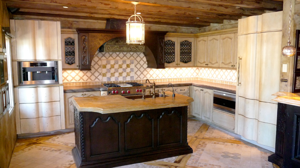 Eclectic kitchen photo in Phoenix with beige backsplash, stone tile backsplash, stainless steel appliances and an island