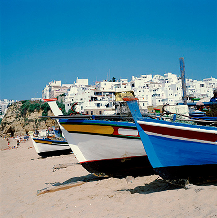Beached Boats with City in the Background Canvas Wall Art